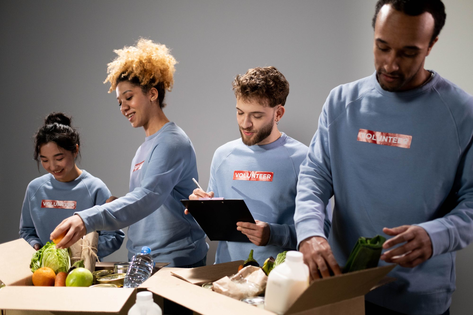 Volunteers gathered around a table preparing a meal