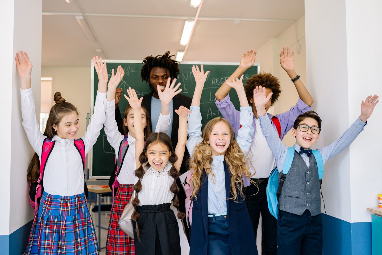 Children in choir robes celebrating with their arms raised