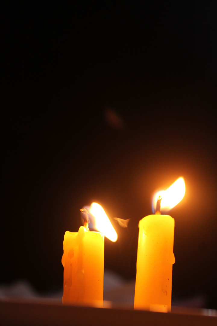 Candles burning in a dark sanctuary