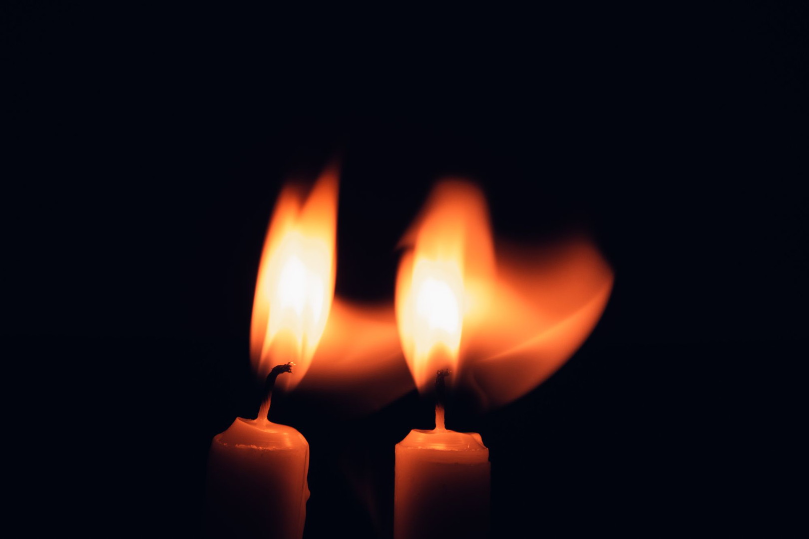 Candles burning in a dark sanctuary